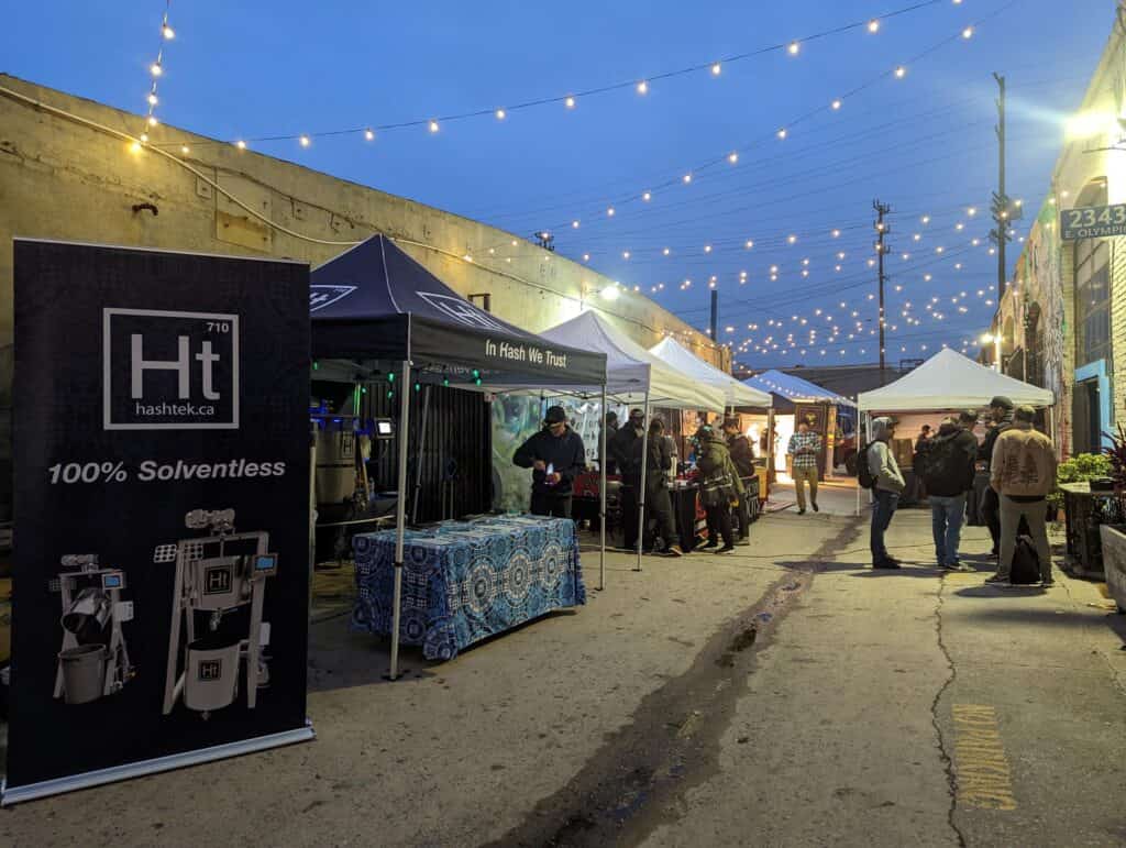 The Hashtek booth lit at dusk on the Legends of Hashish vendor row