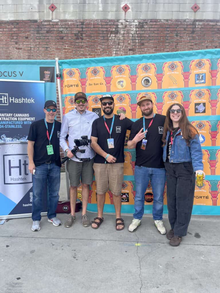 Team Hashtek together in front of the Hashtek banner at Legends of Hashish III
