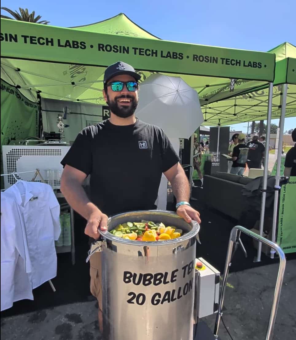 A Hashtek team member with a 20 gallon BubbleTek at the Hall of Flowers booth