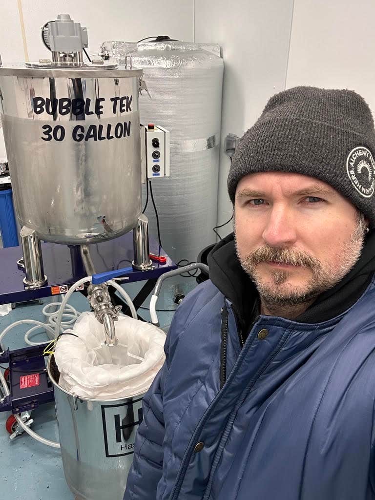 Jack Peele beside Alchemy Pure’s Hashtek 30 Gallon BubbleTek system